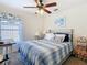 Bright bedroom with a window, desk, and comfortable bed, creating a serene and inviting atmosphere at 439 Madera Pass, Poinciana, FL 34759