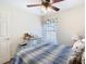 Bedroom with a desk, window, and ceiling fan, offering a peaceful and functional retreat at 439 Madera Pass, Poinciana, FL 34759