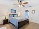 Bedroom with queen bed, ceiling fan, and bedside tables with lamps at 439 Madera Pass, Poinciana, FL 34759