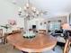 Charming dining room featuring a chandelier, wood table, and comfortable seating at 439 Madera Pass, Poinciana, FL 34759