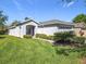 Charming single-story home with well-manicured lawn, shrubbery, and a brick-paved driveway at 439 Madera Pass, Poinciana, FL 34759