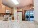 Spacious kitchen featuring modern appliances, hardwood floors, and granite countertops at 439 Madera Pass, Poinciana, FL 34759