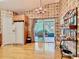 Bright kitchen with hardwood floors, stylish light fixture, and sliding glass doors to outdoor patio at 439 Madera Pass, Poinciana, FL 34759