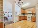 Bright kitchen with light wood cabinets, white appliances, and stylish brick-patterned backsplash at 439 Madera Pass, Poinciana, FL 34759