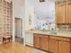 Kitchen featuring wood cabinets, white appliances, and an open view to the living spaces at 439 Madera Pass, Poinciana, FL 34759