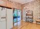 Bright kitchen with hardwood floors, stylish light fixture, and sliding glass doors to outdoor patio at 439 Madera Pass, Poinciana, FL 34759
