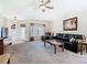 Inviting living room with plush leather seating, ample natural light, and neutral decor at 439 Madera Pass, Poinciana, FL 34759