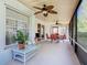 Relaxing screened-in patio with ceiling fans and a dining set, seamlessly blending indoor comfort with outdoor views at 439 Madera Pass, Poinciana, FL 34759