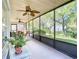 Enclosed patio with ceiling fans and outdoor furniture, perfect for enjoying the serene views and fresh air at 439 Madera Pass, Poinciana, FL 34759