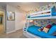 Fun bunk beds with blue comforters and Disney themed wallpaper with a closet in view at 4417 Le Reve Ct, Kissimmee, FL 34746