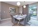 Dining room with table set for eight, modern chairs, decorative lighting, and textured wallpaper at 4417 Le Reve Ct, Kissimmee, FL 34746