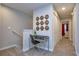 Well-lit hallway with a desk, chair, and tasteful wall decor, perfect for a compact workspace at 4417 Le Reve Ct, Kissimmee, FL 34746