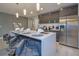 Modern kitchen featuring a large center island with seating, stainless steel appliances, and sleek design at 4417 Le Reve Ct, Kissimmee, FL 34746