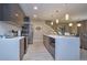 Modern kitchen featuring stainless steel appliances, a white countertop island, and tile flooring at 4417 Le Reve Ct, Kissimmee, FL 34746