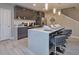 Stylish kitchen with dark cabinets, a breakfast bar with seating, stainless steel appliances, and tile flooring at 4417 Le Reve Ct, Kissimmee, FL 34746