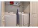 Bright laundry room featuring white washer and dryer with rack for storage at 4417 Le Reve Ct, Kissimmee, FL 34746