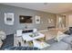 Comfortable living room with a large gray sofa, modern decor, and a sleek white entertainment center at 4417 Le Reve Ct, Kissimmee, FL 34746