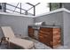 Outdoor kitchen area with a built-in grill, counter space, and a comfortable lounge chair at 4417 Le Reve Ct, Kissimmee, FL 34746