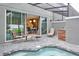 Inviting patio area with outdoor seating, a built-in grill, and a view of the interior dining space at 4417 Le Reve Ct, Kissimmee, FL 34746