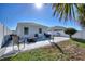 Backyard featuring a paved patio with outdoor furniture, a well-maintained lawn, and a white privacy fence at 4677 Glencrest Loop, St Cloud, FL 34772