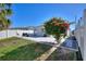Backyard featuring a paved patio with outdoor furniture, a well-maintained lawn, and a blooming pink tree at 4677 Glencrest Loop, St Cloud, FL 34772