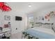 Bright bedroom with a white-painted bed frame, a small desk for studying, and natural light from a window at 4677 Glencrest Loop, St Cloud, FL 34772