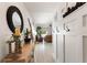 Inviting entryway featuring light wood floors, a modern mirror, and decorative wall hooks for added functionality at 4677 Glencrest Loop, St Cloud, FL 34772