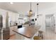 Bright kitchen features a large island, stainless steel appliances, and modern pendant lighting fixtures at 4677 Glencrest Loop, St Cloud, FL 34772