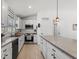 Open kitchen features stainless steel appliances, undermount sink, and ample countertop space at 4677 Glencrest Loop, St Cloud, FL 34772