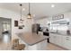 Bright open kitchen features island with seating and stainless steel appliances, perfect for entertaining at 4677 Glencrest Loop, St Cloud, FL 34772