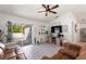 Cozy living room with sliding glass doors, light wood floors, a ceiling fan, and ample natural light at 4677 Glencrest Loop, St Cloud, FL 34772