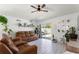 Bright living room with modern decor, white floors, and plenty of natural light, perfect for relaxation at 4677 Glencrest Loop, St Cloud, FL 34772