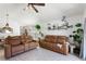 Spacious living room with white floors, and comfortable seating, and seamless flow to other living spaces at 4677 Glencrest Loop, St Cloud, FL 34772
