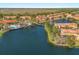 Community aerial view showcasing swimming pool, lake, and orange-roofed buildings at 4692 Sw Golden Beach N Ct, Kissimmee, FL 34746
