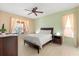 Bedroom featuring neutral paint, a ceiling fan, and lots of natural light at 4692 Sw Golden Beach N Ct, Kissimmee, FL 34746
