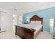 Bedroom featuring wood furniture and adjoining bathroom at 4692 Sw Golden Beach N Ct, Kissimmee, FL 34746