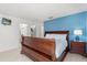 Bedroom featuring wood furniture and adjoining bathroom at 4692 Sw Golden Beach N Ct, Kissimmee, FL 34746