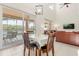 Open-concept dining area with sliding glass doors leading to a covered patio overlooking the water at 4692 Sw Golden Beach N Ct, Kissimmee, FL 34746