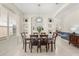 Inviting dining area featuring a modern light fixture, built-in shelving, and large windows at 4692 Sw Golden Beach N Ct, Kissimmee, FL 34746