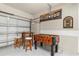 A garage with a foosball table, a table with stools and Hollywood decoration at 4692 Sw Golden Beach N Ct, Kissimmee, FL 34746