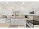 Bright kitchen featuring white cabinets, modern appliances, and lots of counter space at 4692 Sw Golden Beach N Ct, Kissimmee, FL 34746