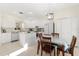 Open kitchen with white cabinets, stainless steel appliances, and adjacent dining area at 4692 Sw Golden Beach N Ct, Kissimmee, FL 34746
