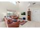 Spacious living room with tall ceilings, large windows, and views of the water at 4692 Sw Golden Beach N Ct, Kissimmee, FL 34746