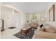 Inviting living room featuring modern decor, large windows, and light tile flooring at 4692 Sw Golden Beach N Ct, Kissimmee, FL 34746