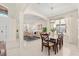 Open-concept living and dining area with neutral colors, arched doorway, and ample natural light at 4692 Sw Golden Beach N Ct, Kissimmee, FL 34746
