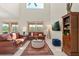 Bright living room with high ceilings, large windows offering water views, and stylish furnishings at 4692 Sw Golden Beach N Ct, Kissimmee, FL 34746