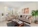 Bright living room featuring neutral furniture, large windows, and tasteful decor at 4692 Sw Golden Beach N Ct, Kissimmee, FL 34746