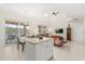 Open-concept living room featuring tile floors, high ceilings, and sliding glass doors to a patio with lake view at 4692 Sw Golden Beach N Ct, Kissimmee, FL 34746