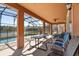 Spacious screened-in patio with pool, dining area, and a beautiful lake view at 4692 Sw Golden Beach N Ct, Kissimmee, FL 34746