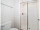 Modern bathroom featuring a glass-enclosed shower with white tile, and a white toilet at 4835 Lullaby Ln, Kissimmee, FL 34746